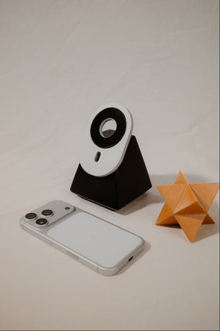 Phone with a stand and origami star on a plain background