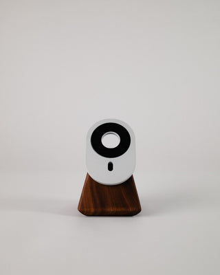 Handmade walnut MagSafe stand on white backdrop