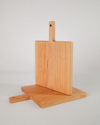Wooden cutting board with a stand on a light gray background