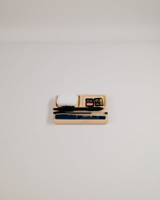 Monolith Desk Tray in maple with pens and small items — front-facing lifestyle shot