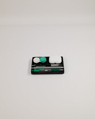 Monolith Desk Tray in black oak with phone and small accessories — front-facing lifestyle shot