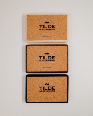 Monolith Desk Tray cork base detail — three trays stacked showing Tilde Woodworking branded cork bottom