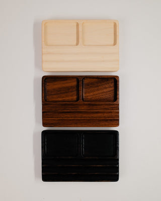 Monolith Desk Tray in maple, walnut and black oak stacked — overhead view showing all three wood variants side by side