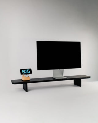Monolith Desk Shelf in black oak styled with Apple Studio Display and Monolith MagSafe Stand — handcrafted wooden desk shelf for monitor riser and desk accessories
