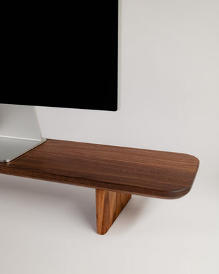 Monolith Desk Shelf walnut surface detail showing monitor stand cutout and rounded edge profile