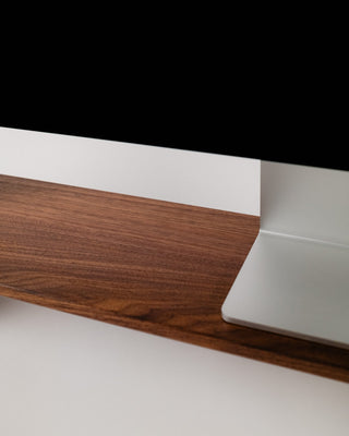 Monolith Desk Shelf corner and leg detail in walnut — softly rounded edges and solid hardwood angled foot