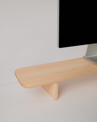 Close-up of Monolith Desk Shelf leg detail in maple — handcrafted angled support with visible wood grain texture