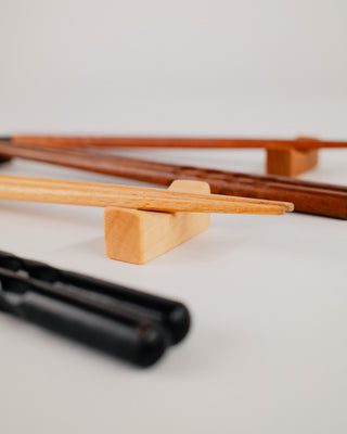 Angled view of chopsticks on maple chopstick rests